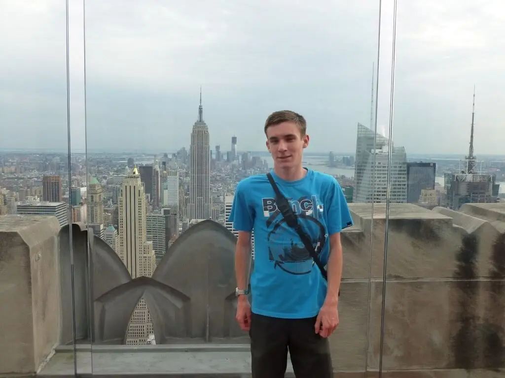 A man with a view of New York behind him