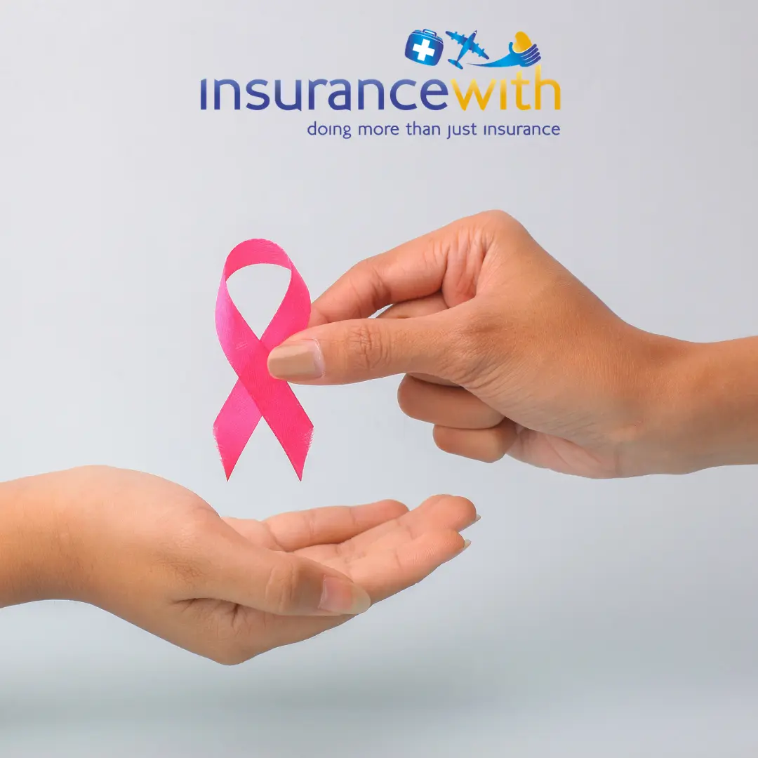 One hand passing a pink breast cancer awareness ribbon into another person's open palm.