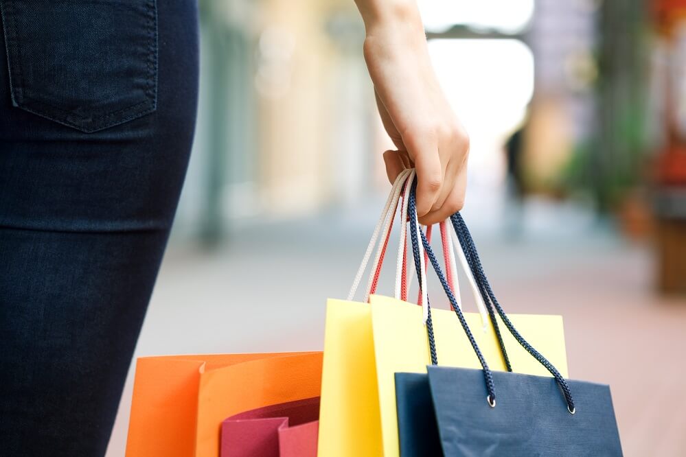 A hand holding shopping bags