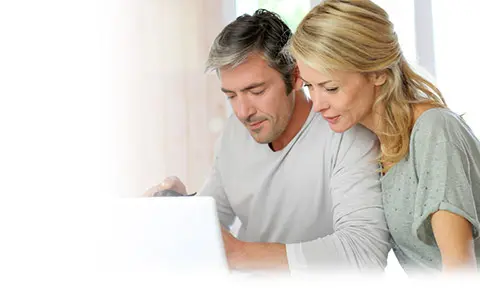 man and woman looking at laptop