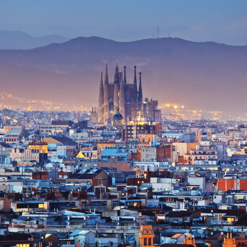 Panoramic skyline view of Barcelona with the Sagrada Família standing out at dusk.