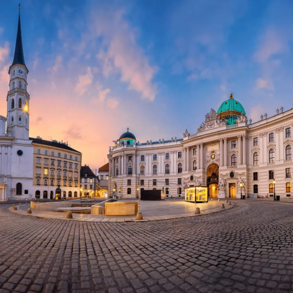 Michaelerplatz square and the Hofburg Palace in Vienna at dusk.
